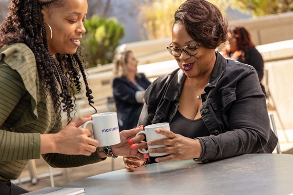 Two employees having coffee outside